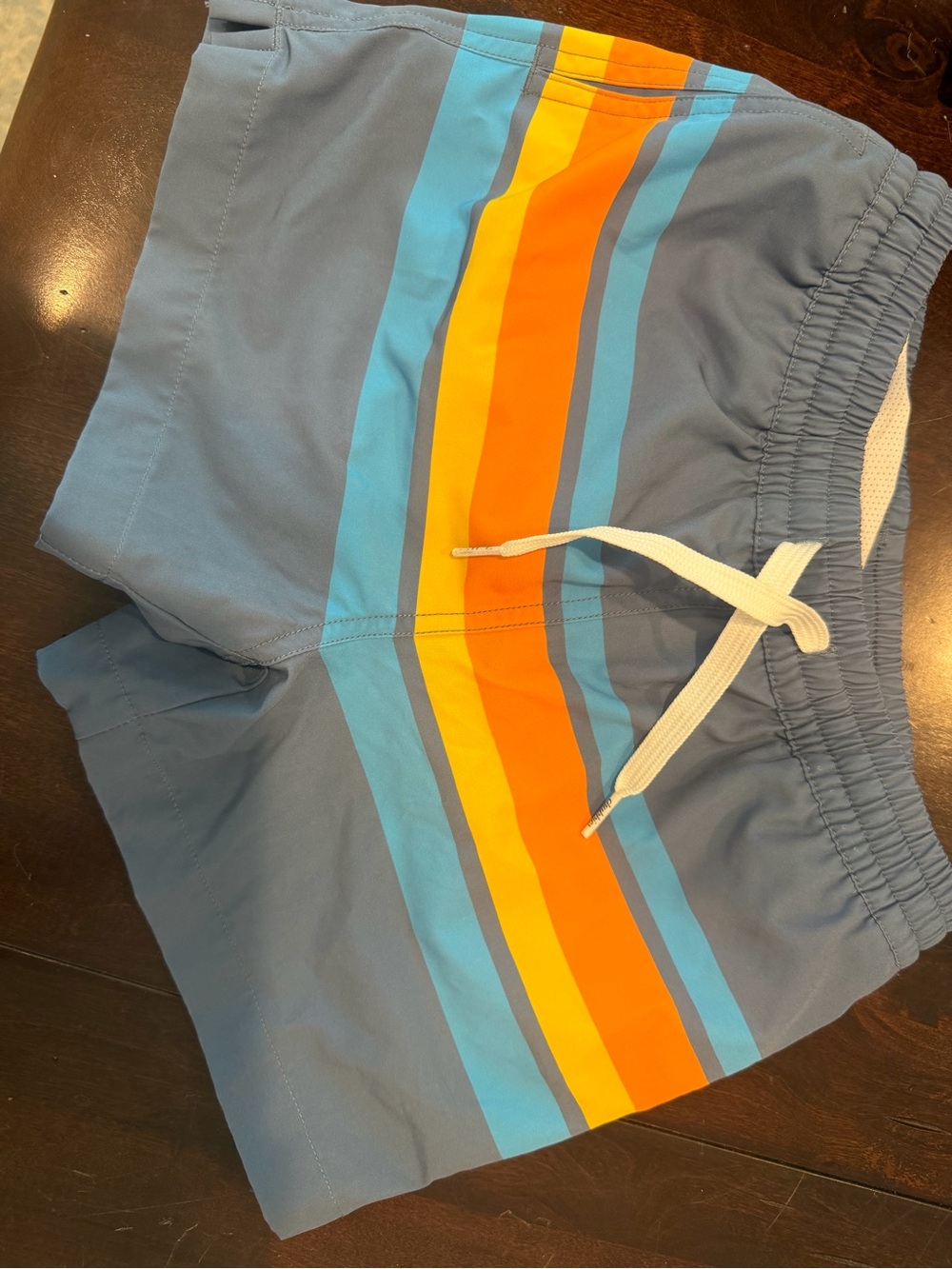 chubbies Kids Blue Swim Trunks with Orange and Yellow Stripe Accents